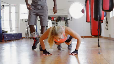 trainer training female boxer in fitness studio 4k