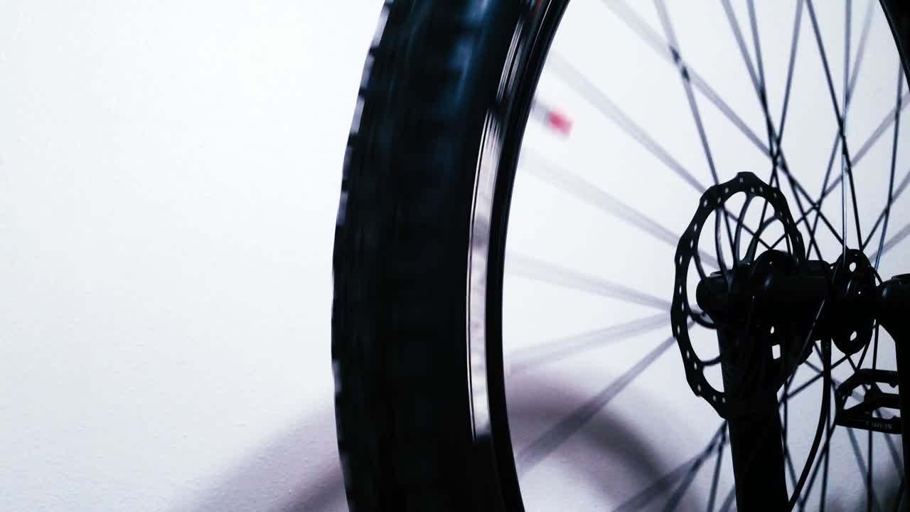 A mountain bicycle wheel spins and displays disc brake
