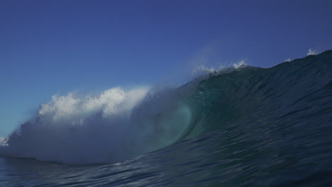 strong ocean wave crashes white wash foam in closeout to view of backside vortex barrel