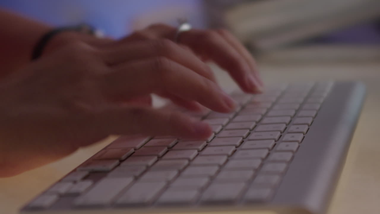 Hands of Woman Tapping on Keyboard in Neon Light, Time Lapse