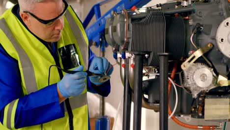 engineer repairing aircraft engineer in hangar 4k