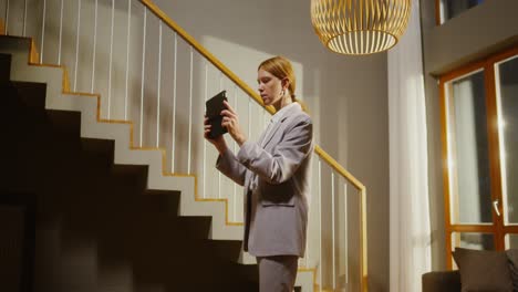 businesswoman using tablet on stairs