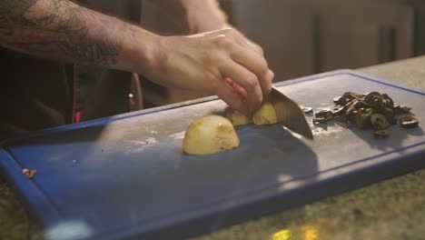 man cooking pizza in the kitchen of restaurant