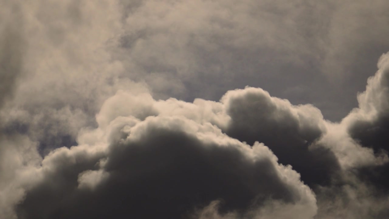 Large Looming Ominous Clouds with High Contrast Rising Fast in Real Time.