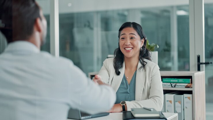 Professional Businesswoman Shaking Hands During an Office Meeting