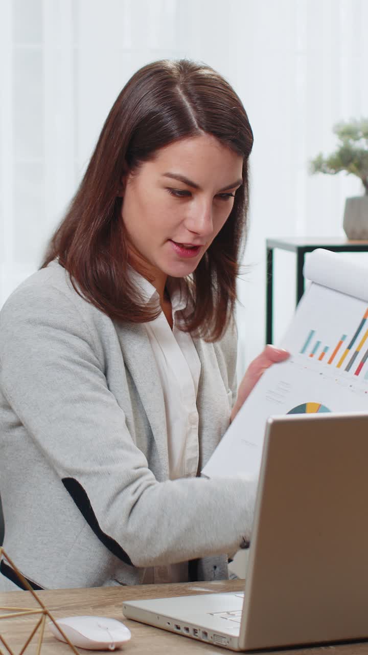 Business woman working on laptop at office online communication video call graphical analytics