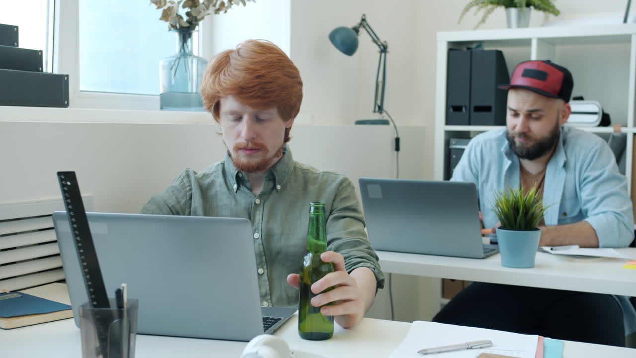 Office Workers Working and Drinking Beer