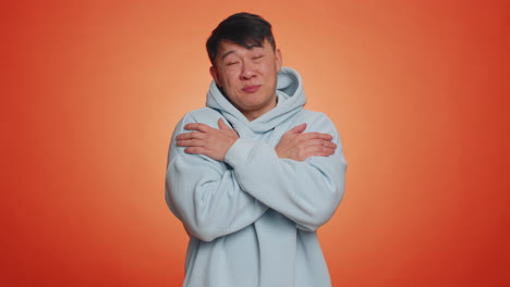 asian handsome man spread hands and give hug embrace to you pleasant expression love happy feelings