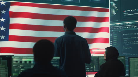 cyber defense experts in a governmental tech room with the american flag