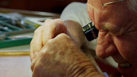 Close-up-of-horologist-repairing-a-watch