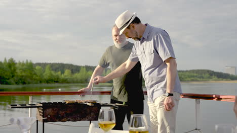 two senior men cooking