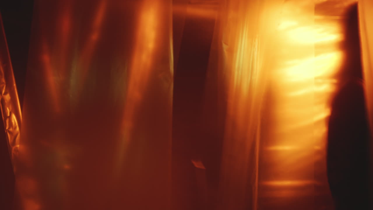 Plastic Curtains Fluttering in Dark Studio with Neon Illumination