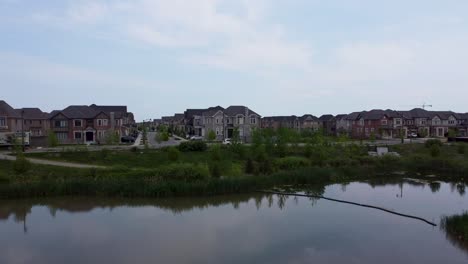 drone flying over a pond on an overcast day in oakville