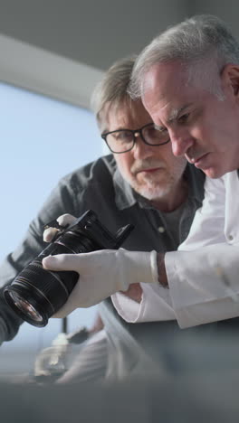 scientists inspecting camera in laboratory