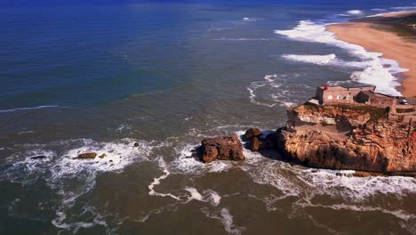 an iconic place on the atlantic coast, the mecca of big-wave surfing. view of nazare's lighthouse in zon north canyon, place with the biggest waves in europe, nazare, portugal