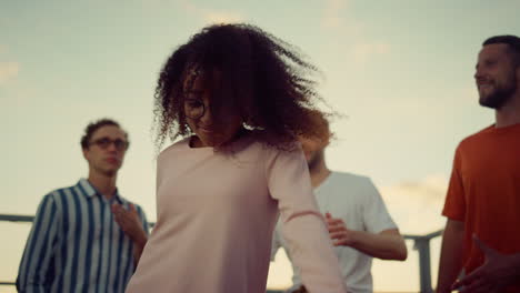 african girl dancing with friends at party. cheerful woman having fun at disco