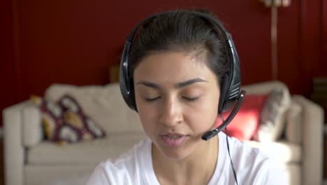 close-up of a young indian woman communicating with a client using a laptop online call conference, training with people