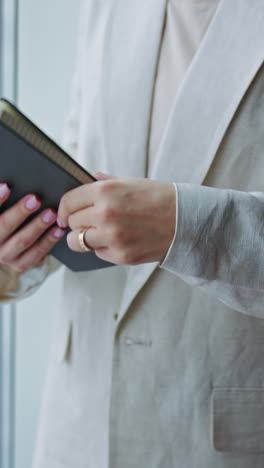close up view of business woman near the window. indoor office businesswoman. vertical video