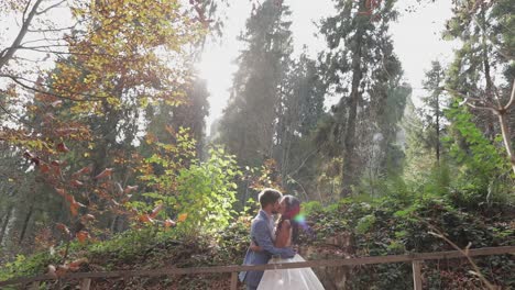 groom with bride near mountain hills in the forest. wedding couple. sunbeams