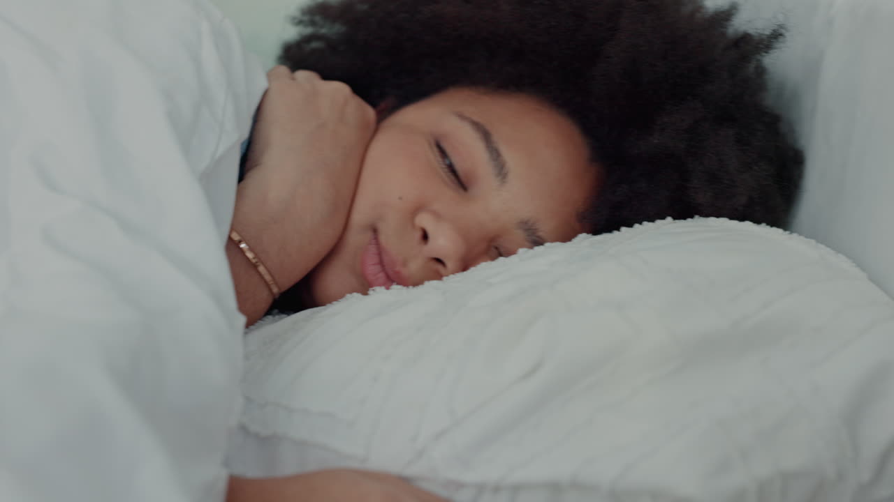 Woman in bed snooze alarm on phone