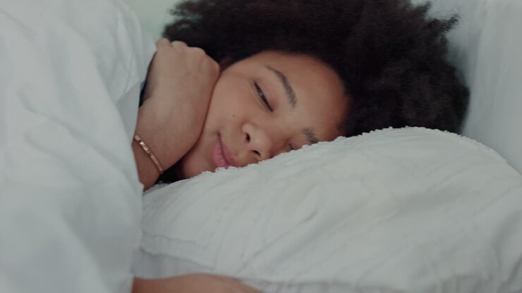 Woman in bed snooze alarm on phone