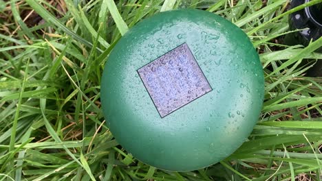 close-up of an ultrasonic mole repellent device placed in a garden. tool designed to deter moles and protect plants from underground pests