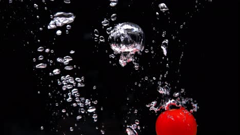 tomatoes splashing into water