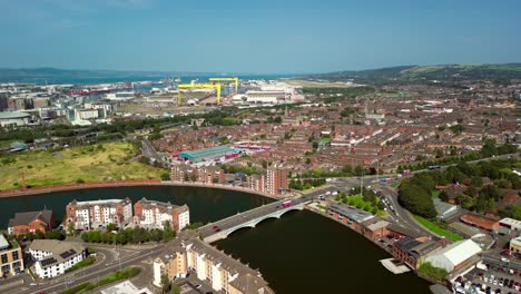 wide descending aerial gv of belfast city centre, northern ireland, uk on a bright and sunny day. produced in 4k, 60fps and with rec709 color