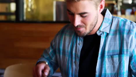 Man-drinking-beer-while-having-burgers