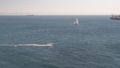 moving boats and cargo ship in open sea near spain, time lapse