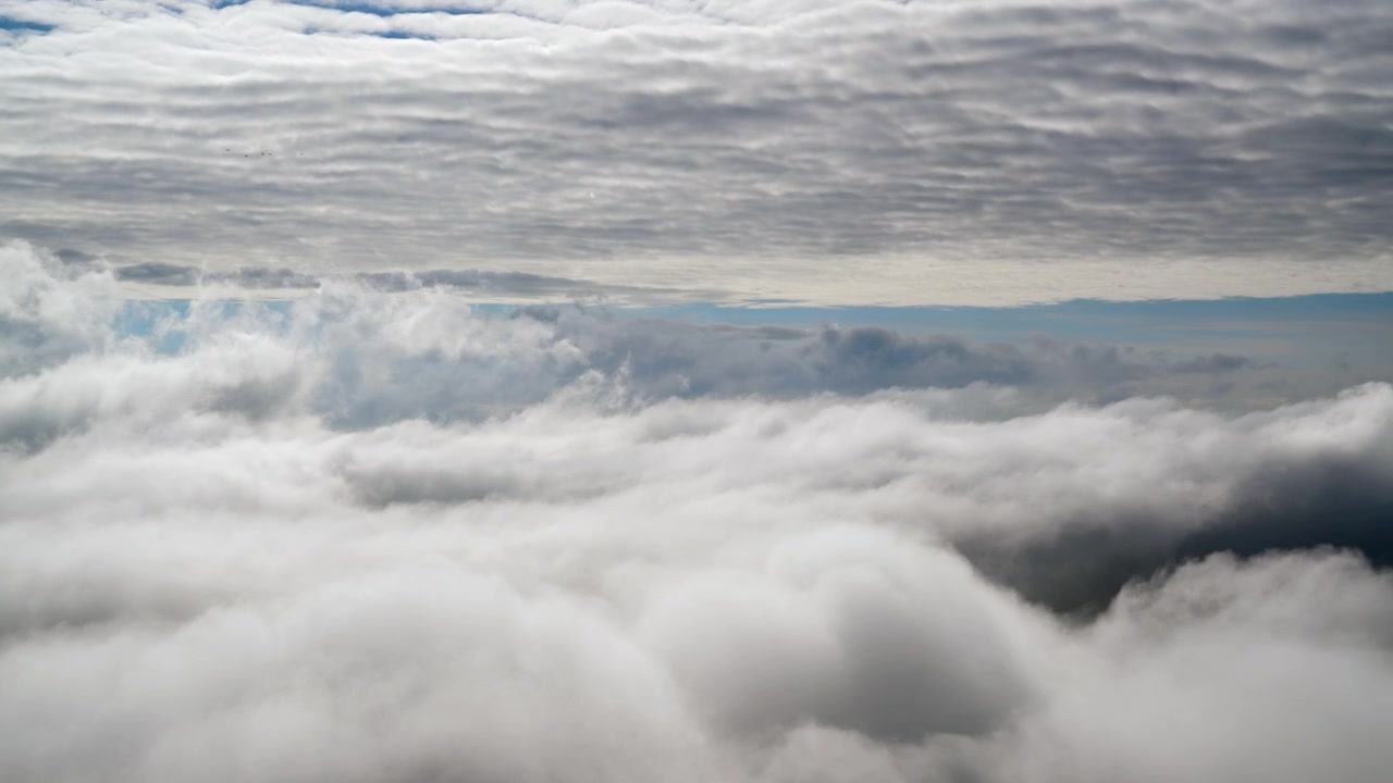 Aerial View of Dense Clouds Moving Over the Horizon