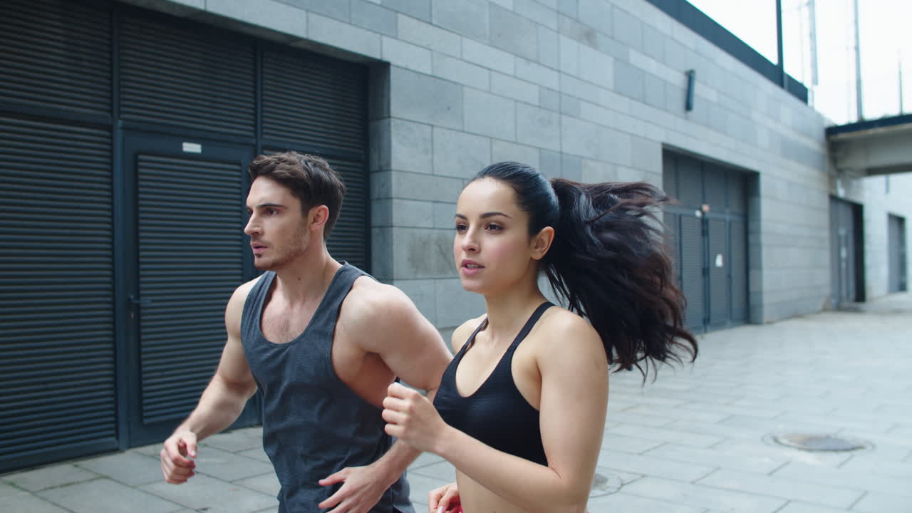 Focused couple running together