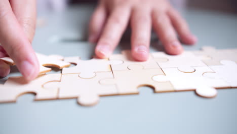 Closeup-hand-of-woman-connecting-jigsaw-puzzle,-Business-solutions,-success-and-strategy-concept