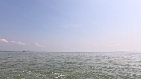 calm sea with waves and distant clouds