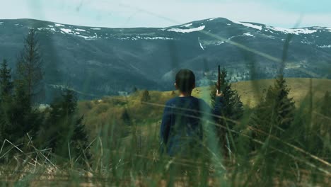 Outdoors-family-activity-in-wild-environment.-Little-boy-walking-across-meadow