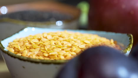 close up of a ceramic bowl of yellow legume beans on a kitchen table