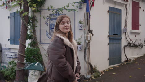 girl photographer looks for the right picture in a alley, biarritz france