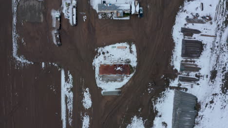 Top-Down-view-of-a-wintery,-snowy-farm-in-Tehachapi,-CA