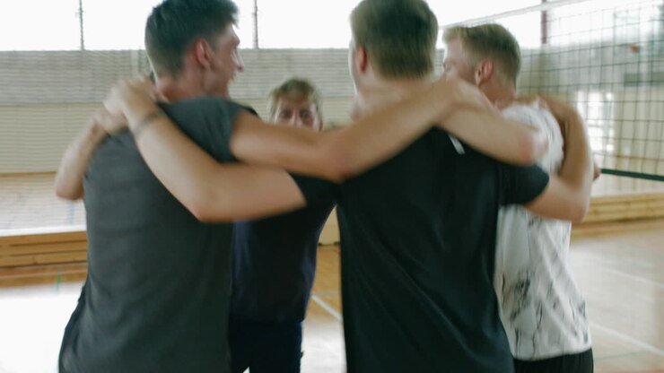Circle of male team players jumps in a circle, celebrating victory - winners