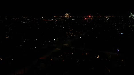 Aerial-View-Of-Fireworks-Going-Off-In-Urban-Street-At-Night