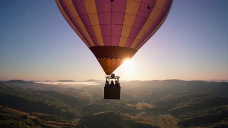 hot air balloon sunrise over mountains