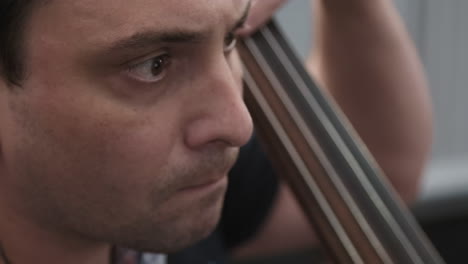 concentrated musician playing contrabass