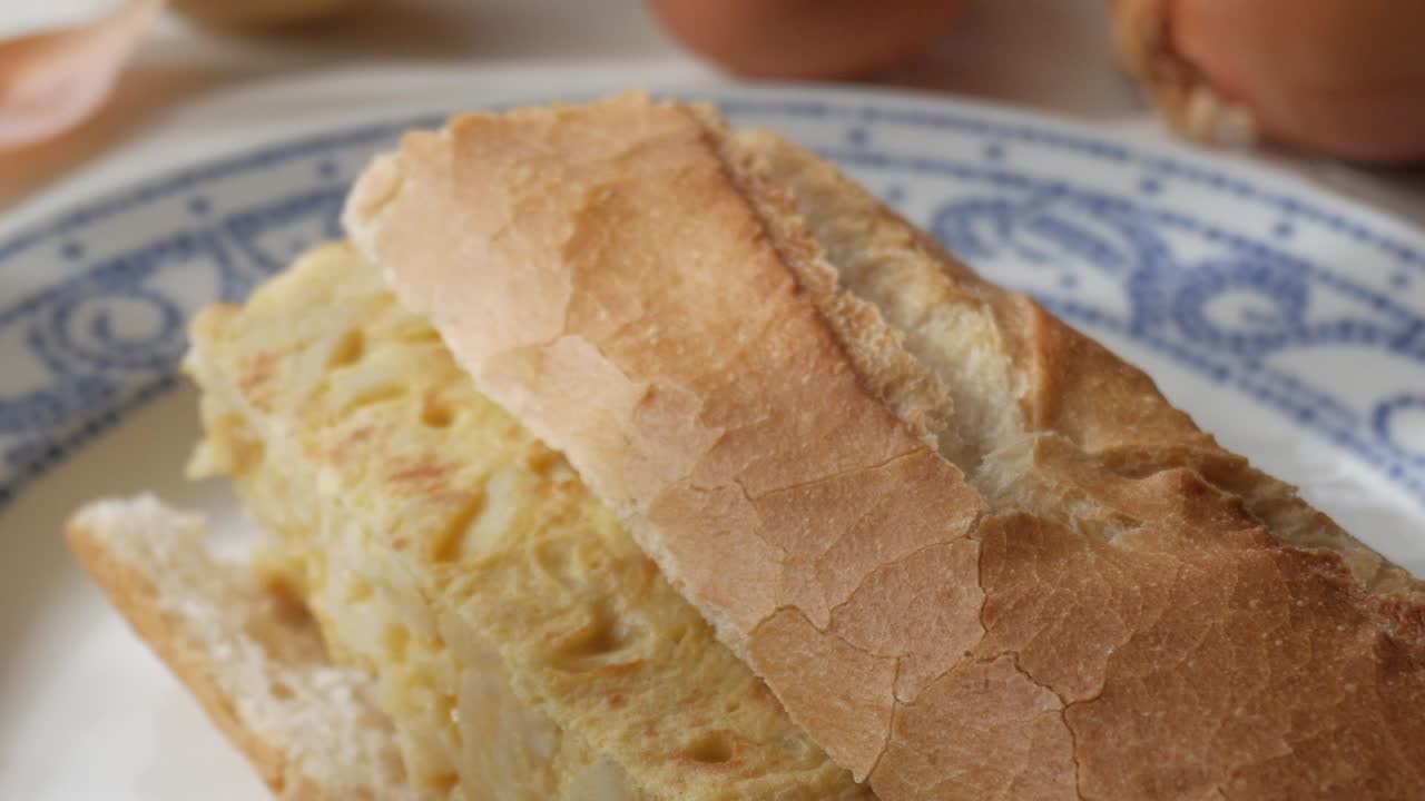 Fresco bocadillo spagnolo con tortilla su un piatto, che presenta uno spuntino delizioso.