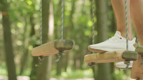 adventure climbing high wire park - people on course in mountain helmet and safety equipment