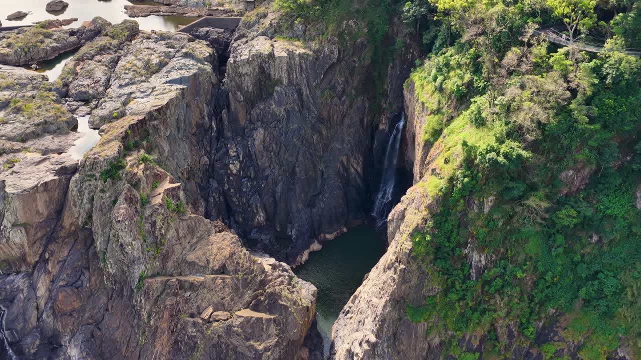 Aerial footage of lush canyon and waterfall