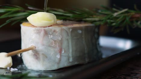 preparing a seasoned fish fillet with herbs