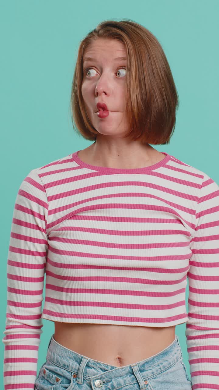 Funny comical playful woman making fish grimace pout lips smooching choking dumb idiotic expression
