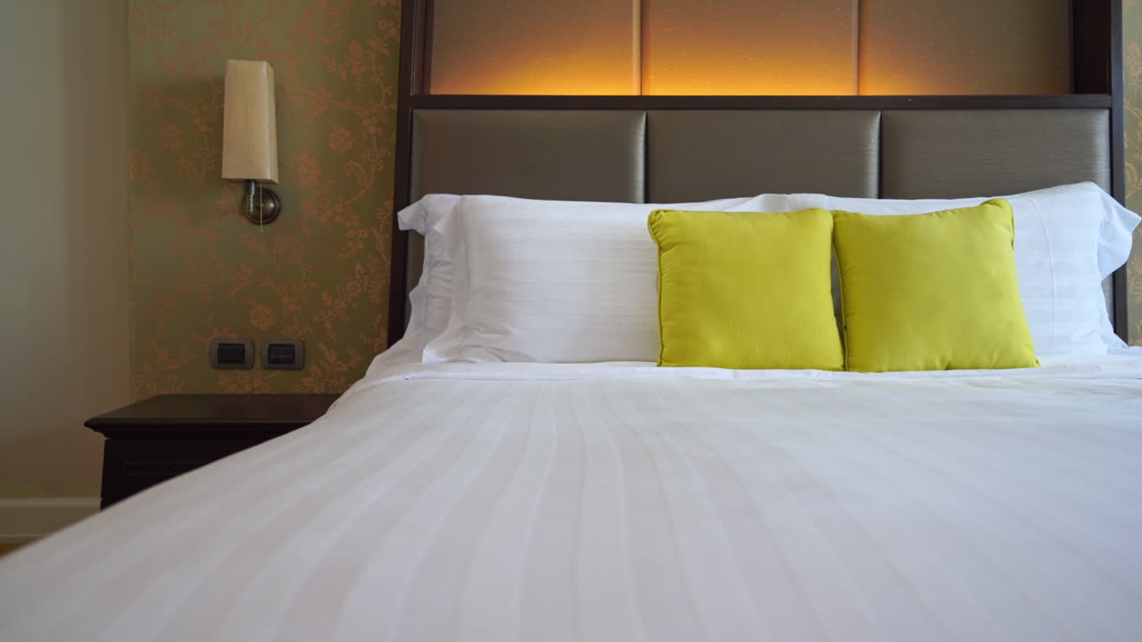 modern Hotel made up bed, yellow and white pillows
