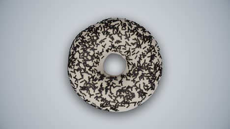 rosquillas sabrosas con glaseado colorido girando y cambiando entre sí en un fondo blanco abstracto