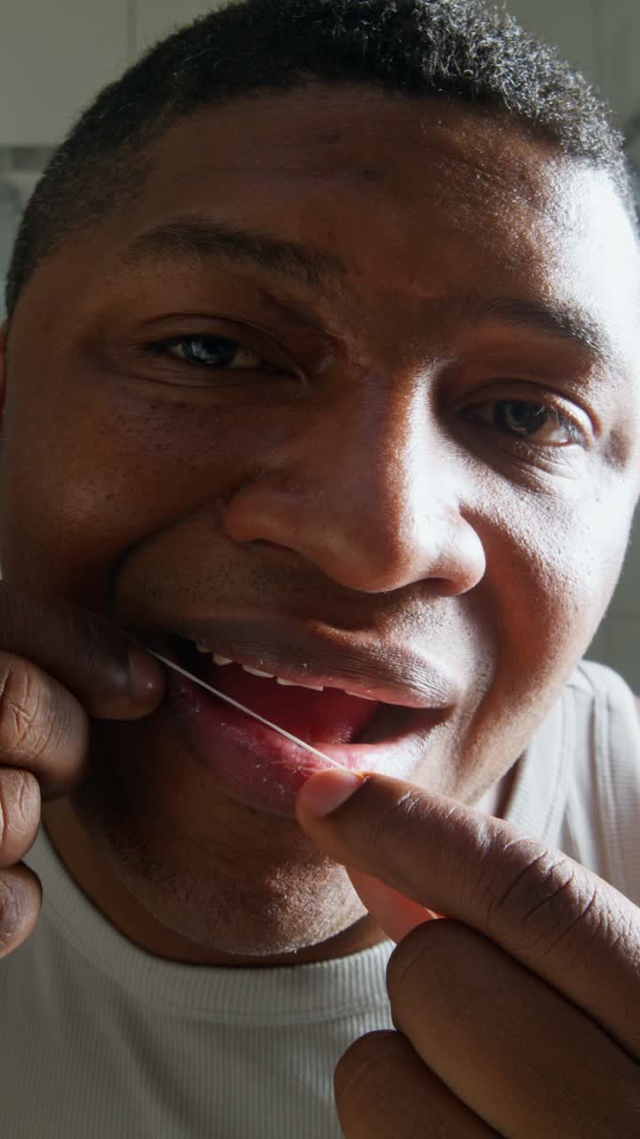 Man Flossing Teeth